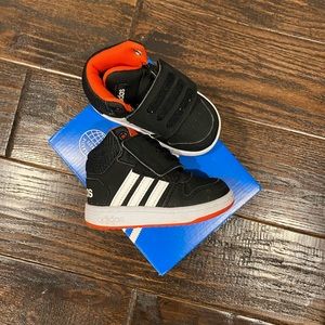 Adidas boys high top sneaker.  Black with white stripes and red accents.  Size 7